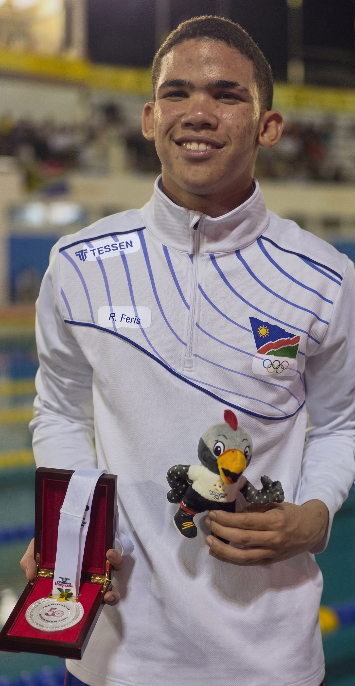 Lorenzo at the Africa Junior Championships, holding medal and mascot